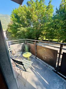 a balcony with a table and chairs on a balcony at Escape Room 04 in Tirano