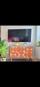 a flat screen tv sitting on top of a entertainment center at Ferienwohnung in der Nähe vom Möhnesee-Arnsberg-Breitenbruch in Arnsberg +6 photos