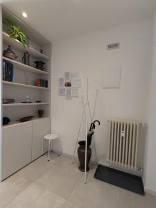 a white room with a radiator and a chair at Design apartment n. 41 in Trento