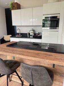a kitchen with a counter with a stove top oven at Modern Design Apartment with Balcon in Nijmegen