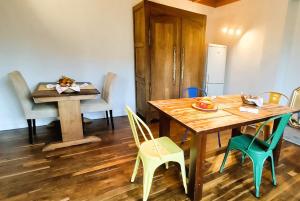 a dining room with a wooden table and chairs at Maison Ciaran in Trébeurden