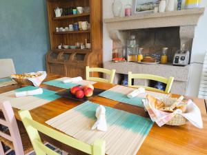 a table with bread and apples on it in a kitchen at Maison Ciaran in Trébeurden