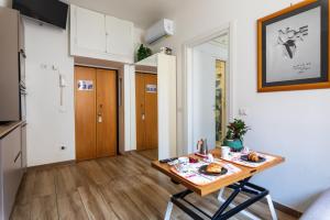 a small kitchen with a table with food on it at Casa DiMì - 2 BR, 2 en-suite bath, 2 min M5, Smart lock in Milan