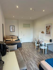 a living room with a bed and a table and chairs at Conscious Stay - Mindful Living in Berlin +17 photos