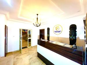 a restaurant with a counter in a room at Deluxe Indulgence Hotel & Suites in Abuja +24 photos