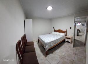 a bedroom with a bed and a staircase in it at Edícula. Ent.independente in Sorocaba