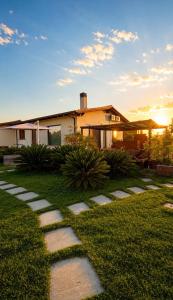 a house with a pathway in front of a yard at Rousmoosen house in Rocca San Giovanni