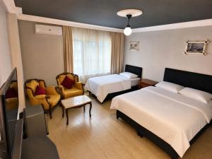 a hotel room with two beds and a tv at Corner Park Suites City Center Corlu in Çorlu +36 photos