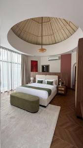 a bedroom with a large bed and a large ceiling at شاليهات رفا in Taif