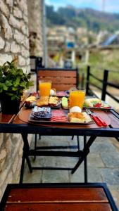 a picnic table with food and drinks on it at 4 Rooms in Gjirokastër
