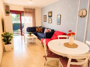 a living room with a couch and a table at Oasis Palm Mar by HelloApartments in Palm-Mar +27 photos