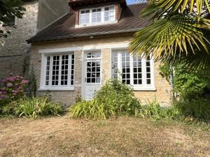 a brick house with a white door and windows at Maisons d'antan Giverny in Giverny