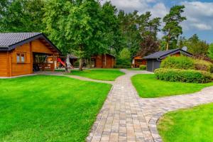 a house with a brick path leading to a house at Waldsiedlung - Haus 11 in Senftenberg