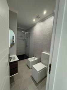 a bathroom with a toilet and a sink and a shower at Marina Puerto in Marina Smir