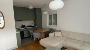 a living room with a couch and a table at North & South Escape Kolašin in Kolašin