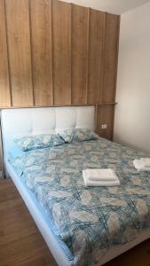 a bedroom with a bed with a wooden wall at North & South Escape Kolašin in Kolašin