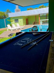 a pool table with two pairs of scissors on it at Quinta Heluue in Ciudad del Este +2 photos