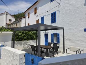 a table and chairs under a canopy on a patio at House Franulich in Stara Baška