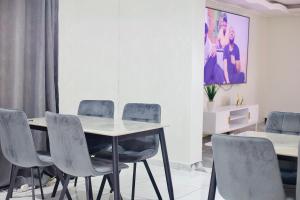 a dining room with a table and chairs at Kumnandi Modern Suite in Beacon Bay +5 photos