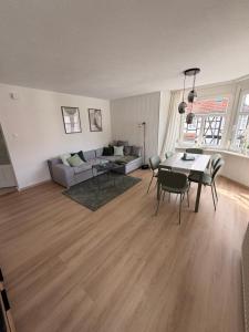 a living room with a couch and a table and chairs at StadtQuartier Gardelegen in Gardelegen