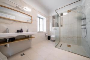 a bathroom with a sink and a shower at Meraki Villa Pelion in Kalamos +99 photos
