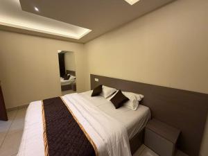 a bedroom with a bed and a bathroom at Hide Away in Padinjarathara
