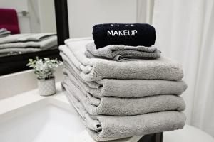 a stack of towels on a counter in a bathroom at Three King Beds Central AC Fireplace Park Disney in Edmonton +178 photos