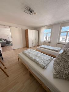 a bedroom with two beds and a living room at StadtQuartier Gardelegen in Gardelegen
