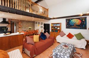 a living room with two couches and a table at The Barn at Bar Hall Bay in Portaferry
