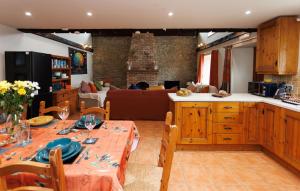 a kitchen and living room with a table and a couch at The Barn at Bar Hall Bay in Portaferry +25 photos