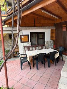 a table and chairs sitting on a patio at Руми in Velingrad