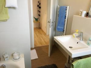 a bathroom with a sink and a mirror at Modern feel-good apartment in Bad Lippspringe +34 photos