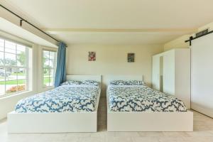 a bedroom with two beds and a window at Island Paradise Villa RNT-01125 in Cape Coral