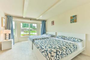 a bedroom with two beds and a window at Island Paradise Villa RNT-01125 in Cape Coral