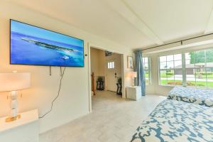 a bedroom with a flat screen tv on the wall at Island Paradise Villa RNT-01125 in Cape Coral +51 photos