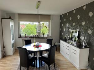 a dining room with a table and chairs at Modern feel-good apartment in Bad Lippspringe