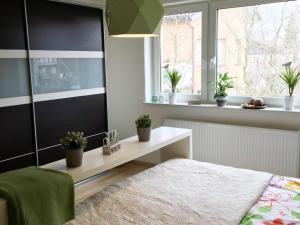 a bedroom with a bed and a table and a window at Modern feel-good apartment in Bad Lippspringe