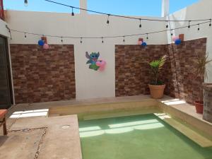 a small swimming pool in a backyard with balloons in it at Casa puerto in Progreso