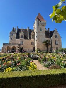 an old castle with a garden in front of it at Stunning Boutique gîte Flore at Vive le Vert in Bussière-Badil