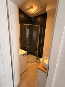 a bathroom with a sink and a toilet and a mirror at Apartament centrum in Białystok