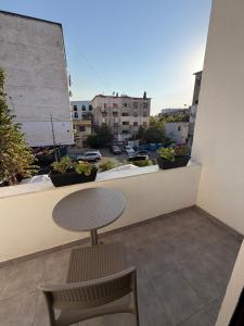 a table and chairs on a balcony with a view at Velor Boutique Hotel in Tirana