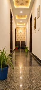 a hallway with chairs and plants in a building at Hotel Regal Delight Star Taj - Best Rated Area #hygienic and Affordable Rooms, Check in Guarantee,Near Taj mahal in Agra