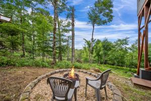 a fire pit in a yard with two chairs and a table at Viewtopia in Beech Mountain