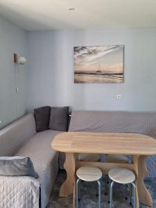a living room with a couch and a table at Jūras sāga in Pāvilosta