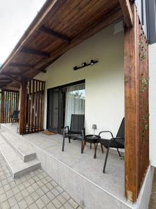 a patio with chairs and a table on a building at Cabanutele "La Garaj" in Ocna-Mureşului