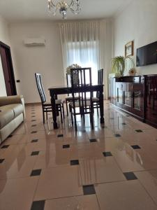 a living room with a dining room table and chairs at Casa 2019 in Matera