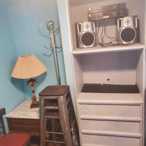 a book shelf with two speakers and a lamp at ARMANI MANOR Rustic UNIT 2 in Wildwood