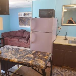 a kitchen with a refrigerator and a table and a couch at ARMANI MANOR Rustic UNIT 2 in Wildwood