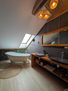 a bathroom with a large tub and a sink at Kierunek Puszcza 2 Apartamenty - Balia, Sauna, Grota solna - max 14 osob in Narewka
