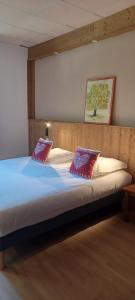 a bed with two pillows on it in a room at Abries Hôtel in Abriès
